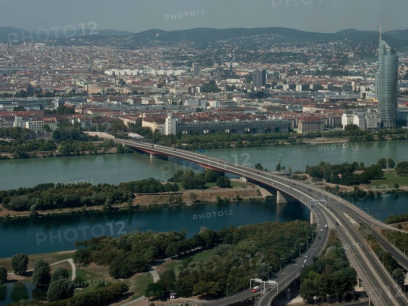 Expansive city view with rivers, bridges and mountains visible in the background, Vienna, Austria, Europe