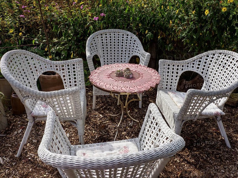 Four white woven garden chairs around a small table, ideal for relaxed summer afternoons outdoors, SChermbeck North Rhine-Westphalia, Germany, Europe