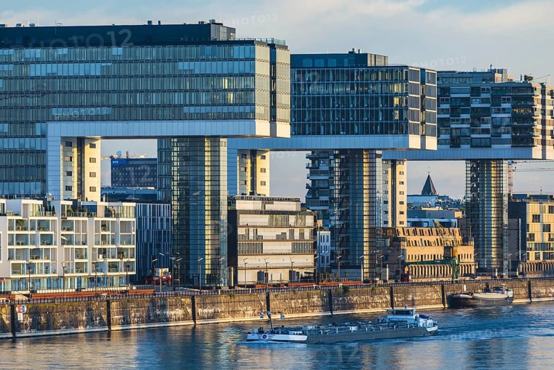 Crane houses in the Rheinau harbour, seen across the Rhine from the south bridge, Cologne, North Rhine-Westphalia, Germany, Europe