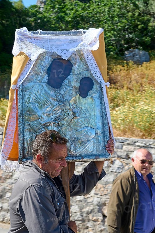 Man carrying a religious icon during a procession, Procession of the icon Panagia Skiadni from Monolithos via Siana to Skiadi Monastery, near Monolithos village, Rhodes, Dodecanese, Greek Islands, Greece, Europe