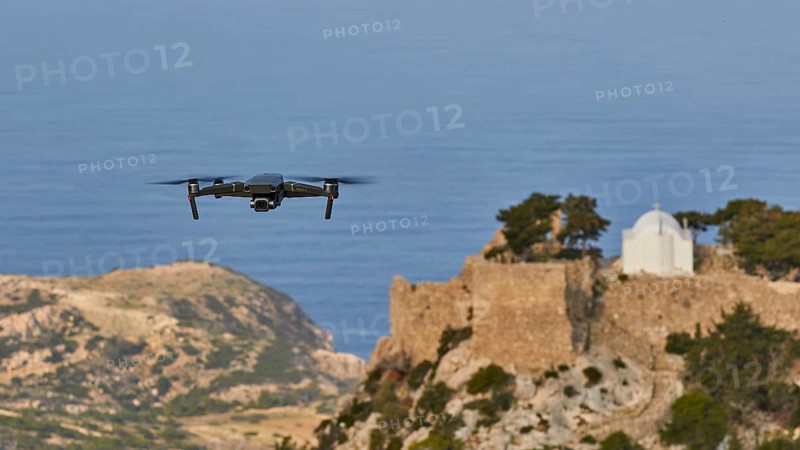 Drone flies over a castle ruin with chapel on a rock in front of the wide sea, Chapel of Saint Panteleimon, Kastro Monolithou, Castle Monolithos, rock castle, village Monolithos, Rhodes, Dodecanese, Greek Islands, Greece, Europe