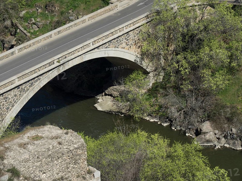 Stone bridge over a river with neighbouring trees and rocks, Toledo, Spain, Europe