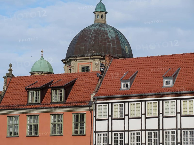 Historic buildings with red tiled roofs and a large dome under a partly cloudy sky, Gdansk, Poland, Europe
