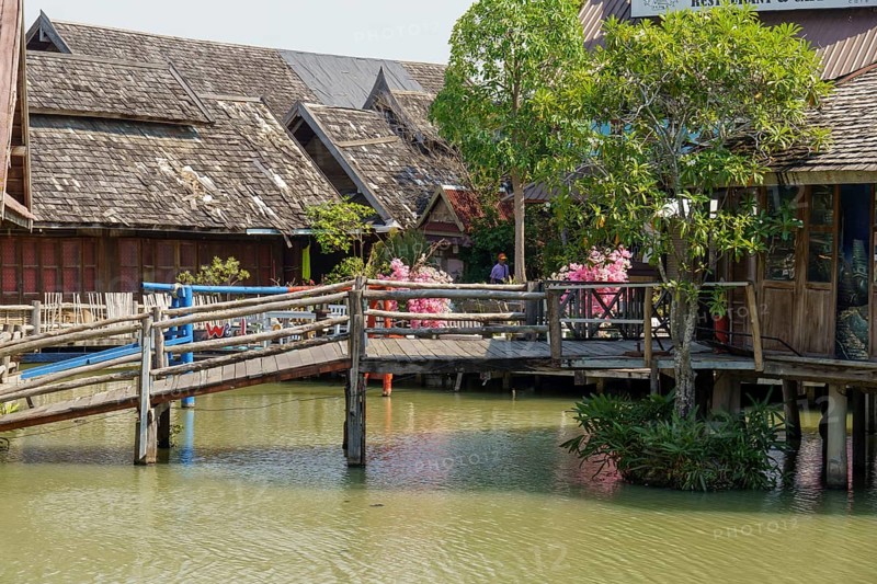 Wooden bridge and traditional houses around a quiet canal at the floating market, Pattaya, Thailand, Asia
