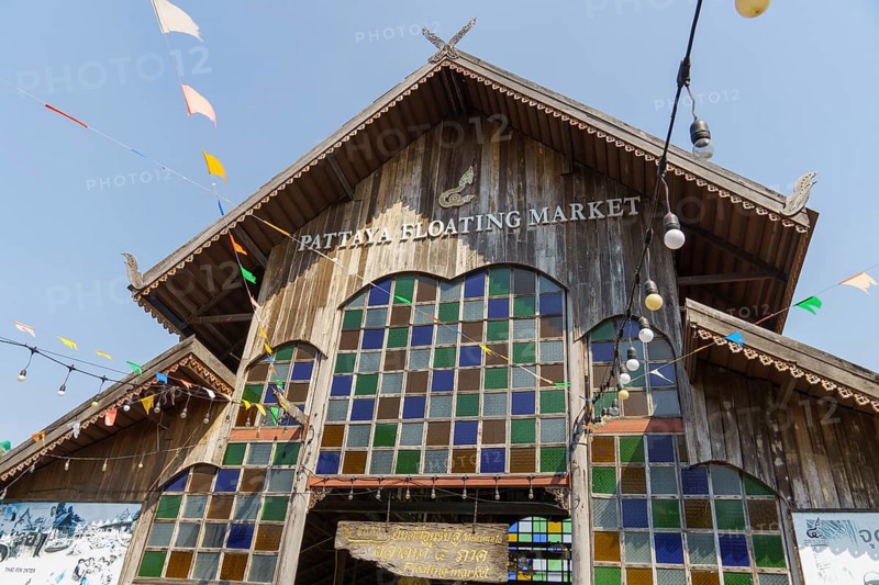 Entrance to the Pattaya Floating Market, a wooden building with colourful windows and decorative lanterns, Pattaya, Thailand, Asia