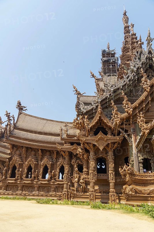 Wide-angle view of a section of the wooden temple, with detailed decorations and sculptures, blue sky, Pattaya, Thailand, Asia