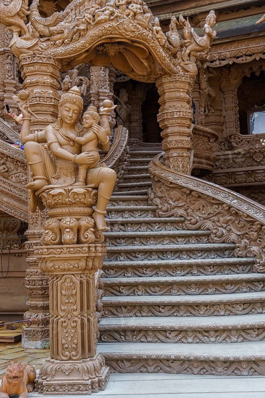 Close-up of an ornate wooden staircase inside the temple, with sculptures and carvings, Pattaya, Thailand, Asia