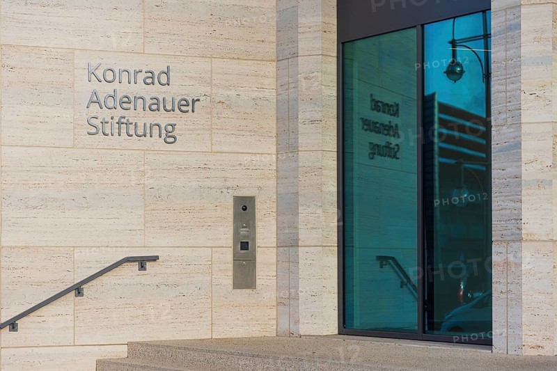 The lettering of the Konrad Adenauer Foundation reflecting in the window