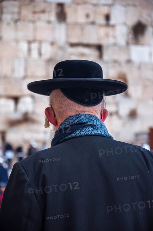 Religious orthodox jew from behind at the Western Wall in the old city of Jerusalem Israel