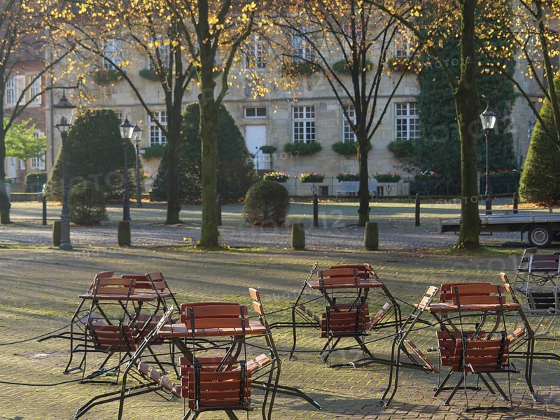 Square with abandoned seats in autumn sunlight, nottuln, münsterland, germany