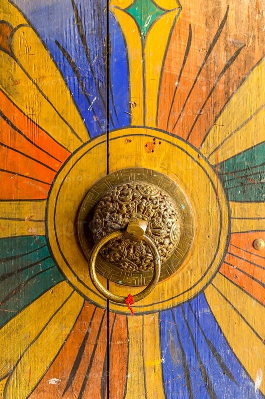 Golden door knob on a red wooden door
