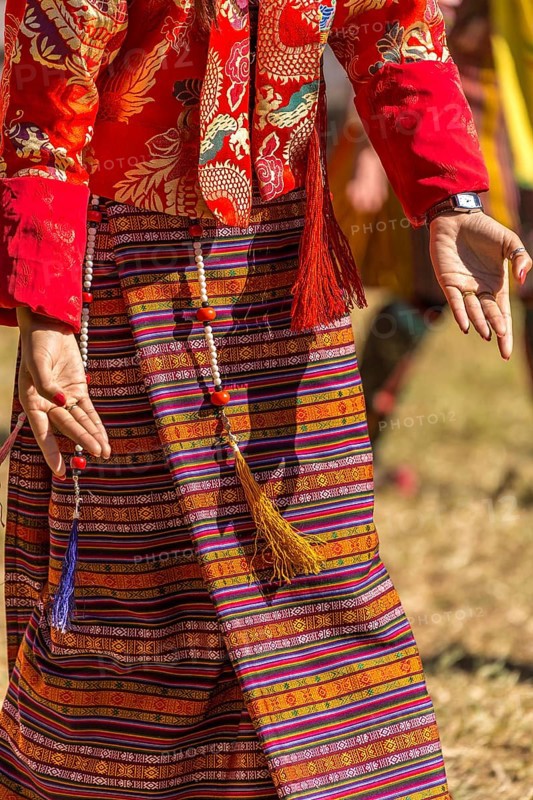 Dancer in traditional colorful clothing at a tshechu festival in Bhutan