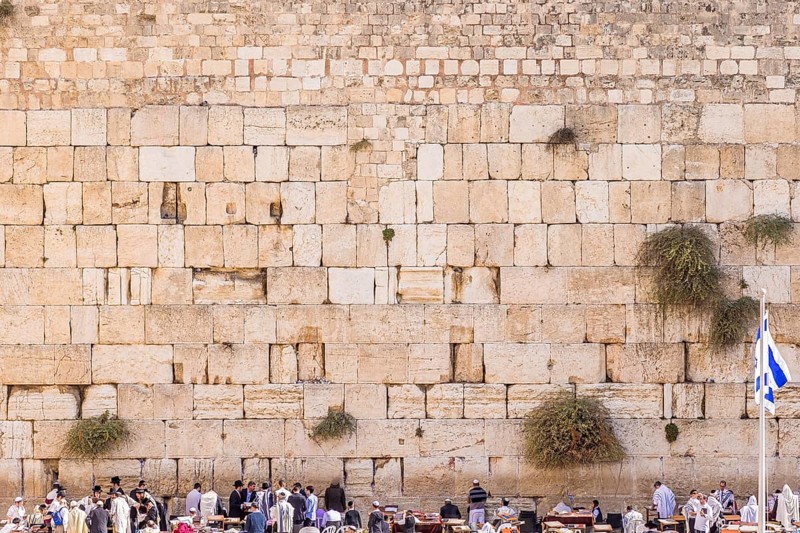 The Western wall in Jerusalem with state flag of Israel