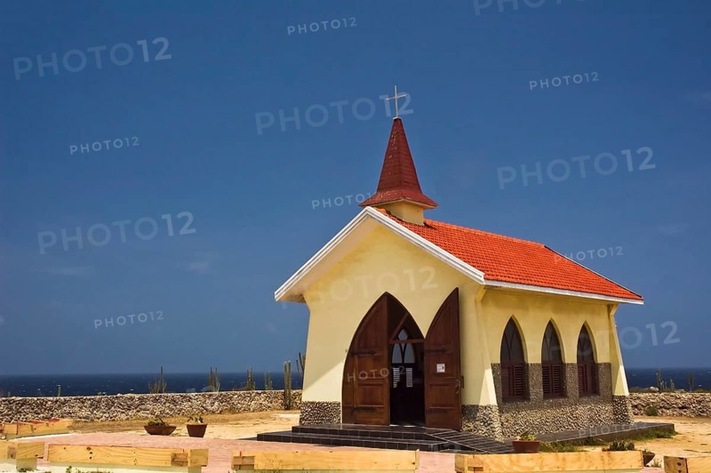 A bright yellow small Catholic chapel that stands on the hills above the north shore and to the northeast of the town of Noord, on the island of Aruba
