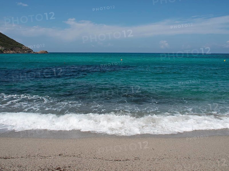 Waves crashing on a sandy beach, with a sweeping view of the open sea and the horizon, ajaccio, corsica, france