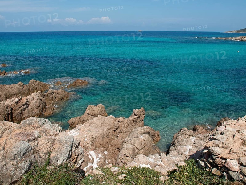 Rocky coastline with clear turquoise water and lush nature, ajaccio, corsica, france