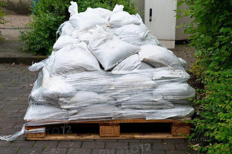 Sandbags for flood defense, river Moselle Trier in Rhineland Palatinate, flooded trees and paths, high water level, climate change