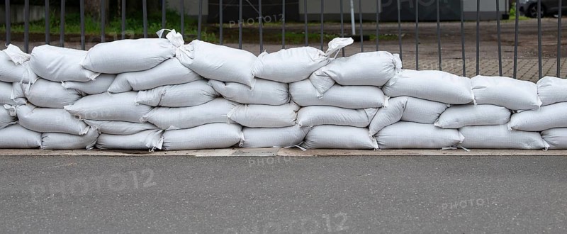 Sandbags for flood defense, river Moselle Trier in Rhineland Palatinate, flooded trees and paths, high water level, climate change