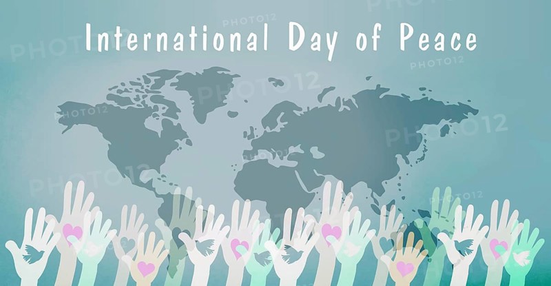 Hand with dove and heart, international peace day, faith, freedom, charity and help concept, humanitarian aid, world map