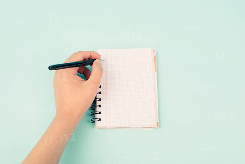 Left handers day, empty notebook, writing with the left hand, pen and table