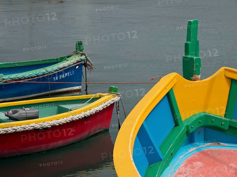 Multicoloured boats with bold colours docked in the water, marsaxlokk, mediterranean sea, malta