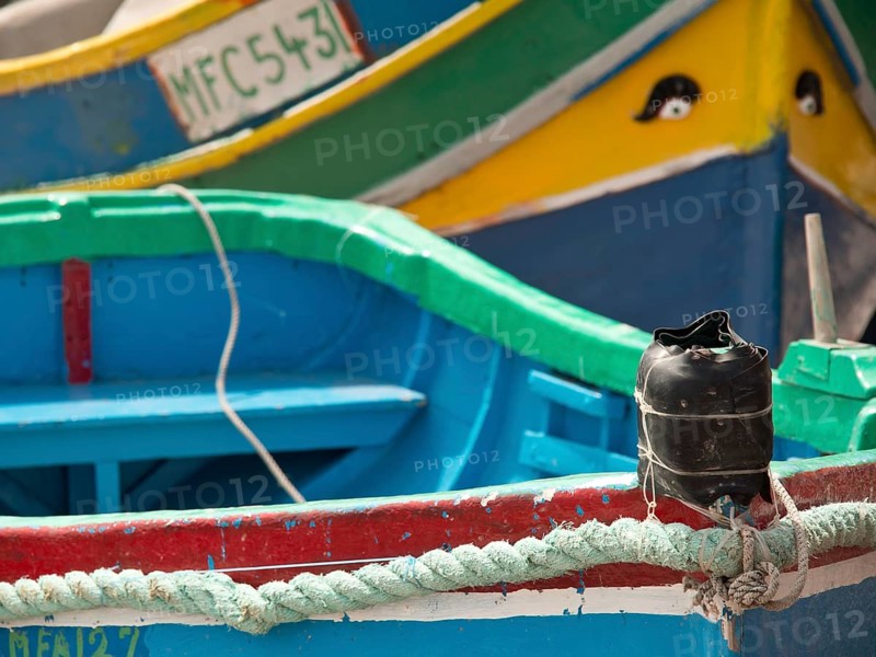 Detailed view of colourful boats docked at the harbour, marsaxlokk, mediterranean sea, malta