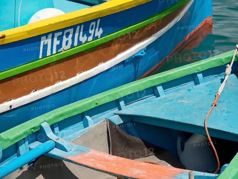 Close-up of several colourful boats lying in the water of a harbour, marsaxlokk, mediterranean sea, malta