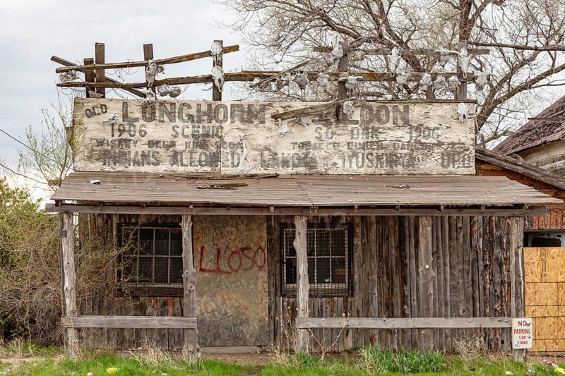 Scenic, South Dakota, The small town of Scenic, now mostly abandoned, between Badlands National Park and the Pine Ridge Indian Reservation. The Old Longhorn Saloon decorated its building with skulls. It sign said Indians Allowed.
