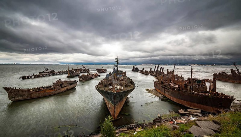 Abandoned and rusty shipwrecks in the sea under an overcast sky, atmosphere melancholic and gloomy, symbol photo ship graveyard, AI generated, AI generated