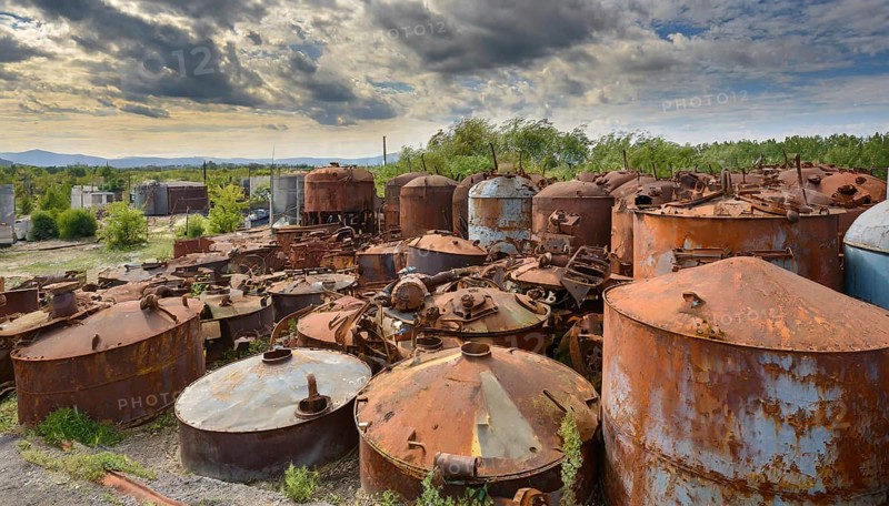 Rusty tanks in a junkyard under a partly cloudy sky, symbol photo, AI generated, AI generated