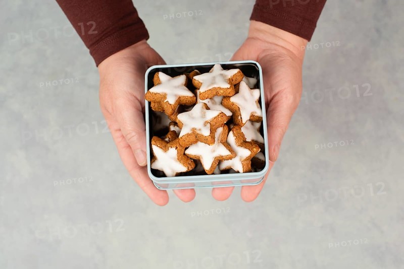 Cinnamon stars, Zimtsterne traditional german christmas cookies in a box, gingerbread with anise spice for holidays