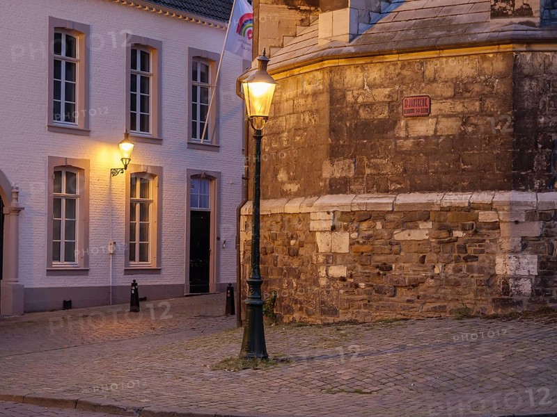 Cosy street corner with lantern lighting and old buildings at night, Maastricht, limburg, netherlands