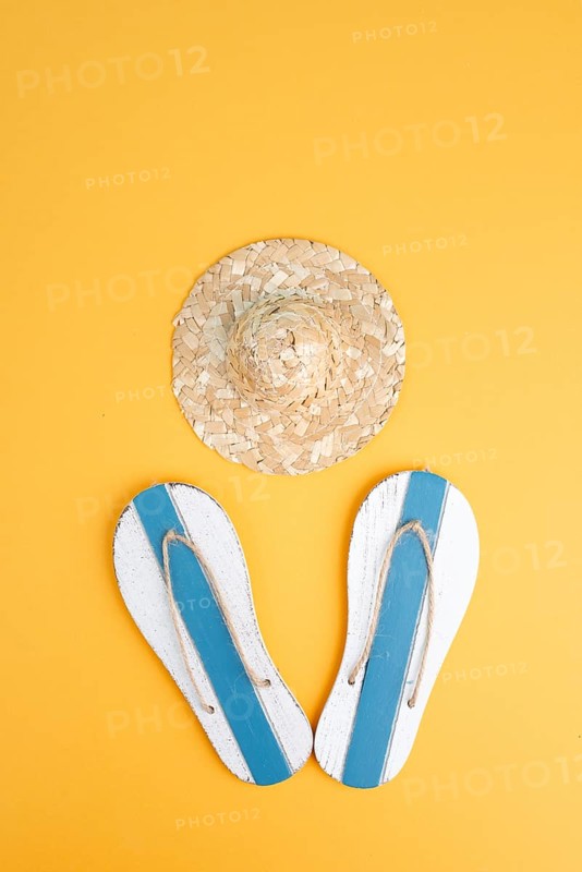 Summer vacation by the sea, flip flops and a straw hat, travel and tourism concept