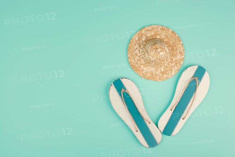 Summer vacation by the sea, flip flops and a straw hat, travel and tourism concept
