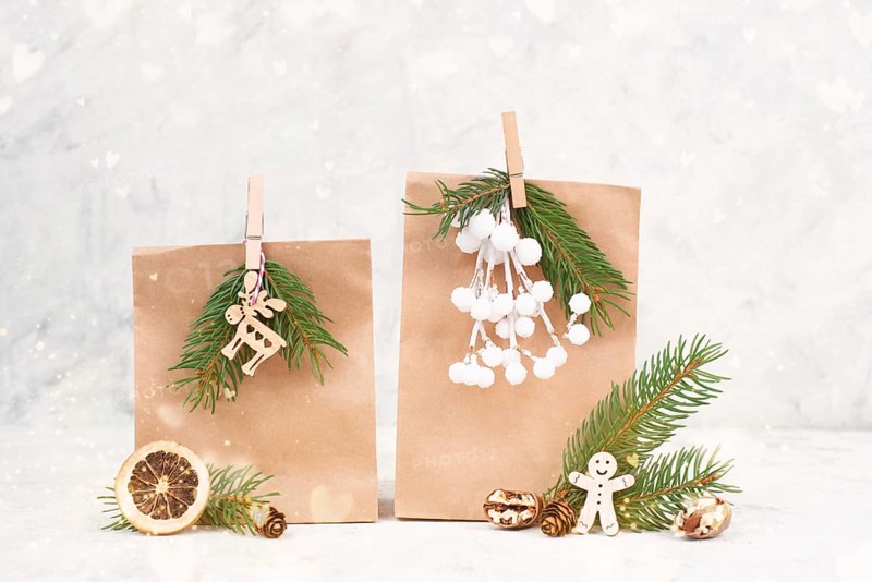 Christmas holiday gift bags for suprise, fir branches, gingerbread man, elk, snow covered berries and nuts, blank tag with copy space