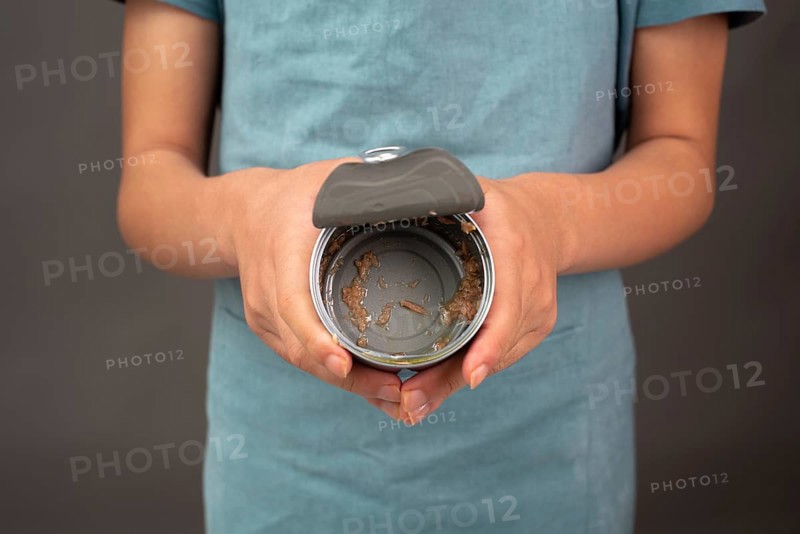 Open tin can with preserved food, empty box of tuna fish, processed ingredients, feeding a pet
