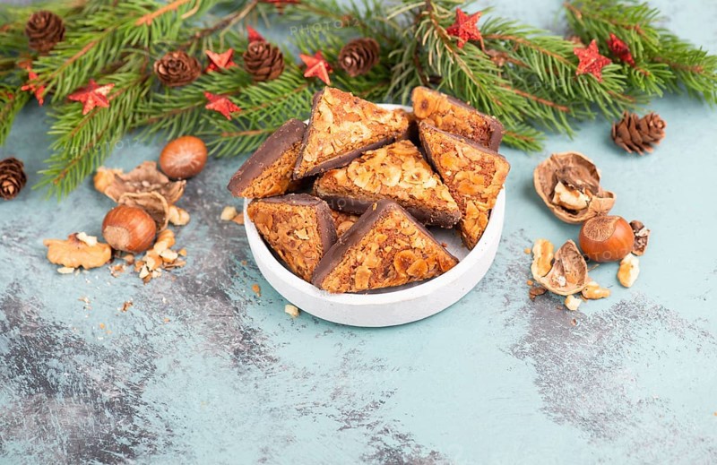 Nut corner triangles, traditional german sweets called Nussecke, covered with chocolate, christmas cake