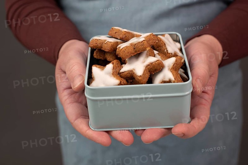 Cinnamon stars, Zimtsterne traditional german christmas cookies in a box, gingerbread with anise spice for holidays