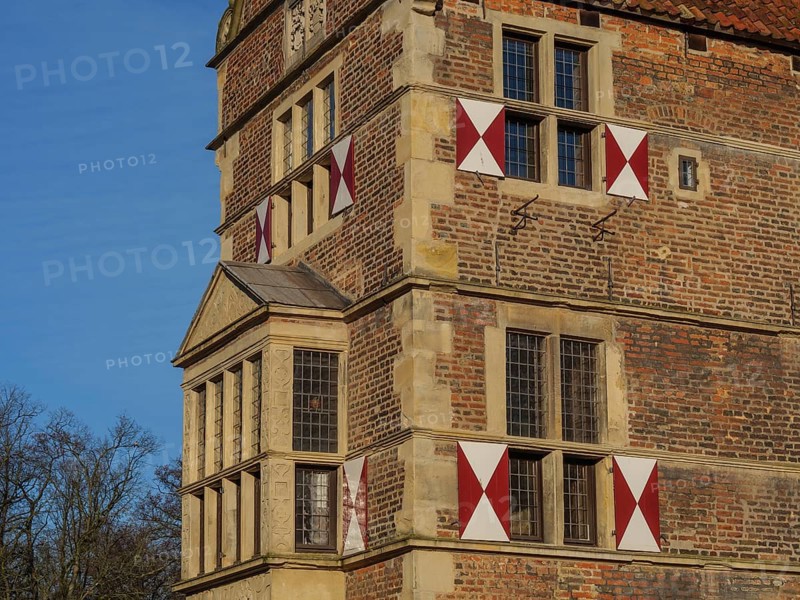 Detail of a historic castle with red and white shutters and a small tower, lüdinghausen, westphalia, germany