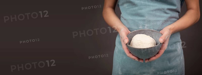Fresh wheat dough, baker holds bowl with flour, bread or pizza, prepare ingredients for food, baking pastry