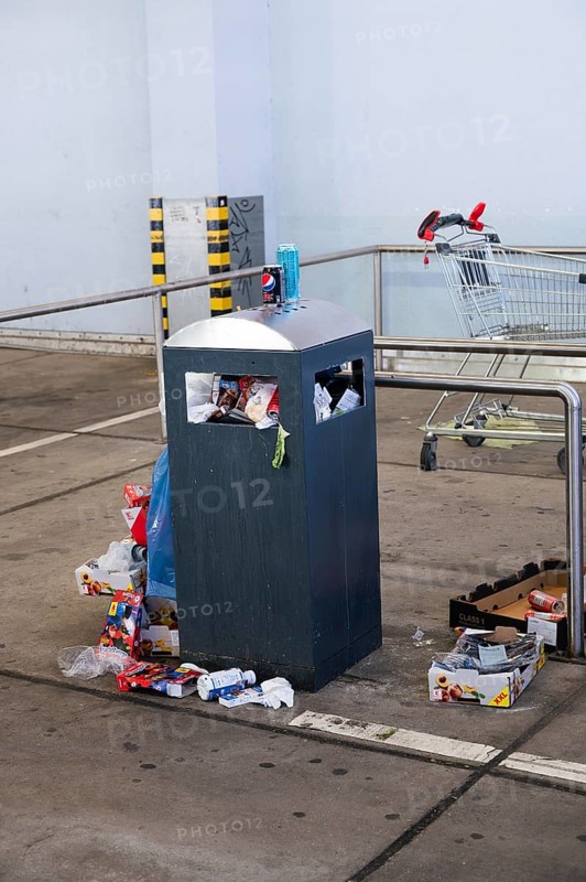 Overflowing dumpster, trash can with plastic bags and cardboard, filthy shopping center, Alleencenter in Trier, Germany, Europe