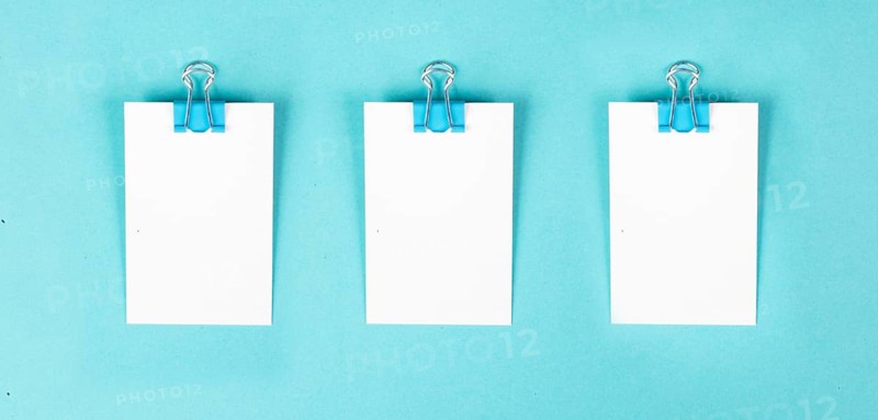 Blank white paper with a paperclip, reminder or message in the office, communication concept