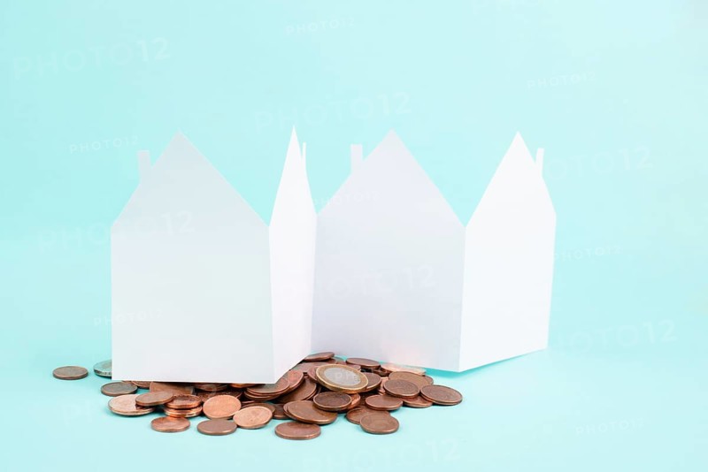 Paper house with Cent coins, planning to buy, build or rent a new home, real estate concept, owning property, bank loan