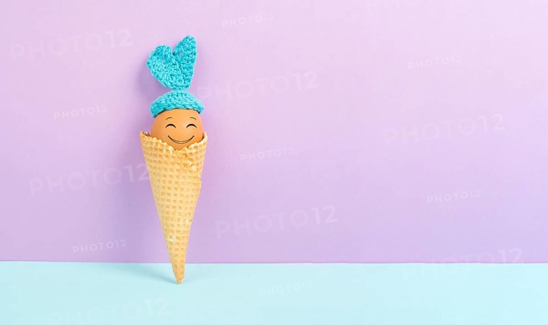 Cute easter bunny or rabbit with a smiling egg face in an ice cream cone, spring holiday, greeting card