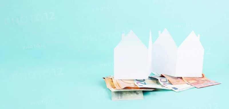 Paper house with Euro banknotes, planning to buy, build or rent a new home, real estate concept, owning property, bank loan