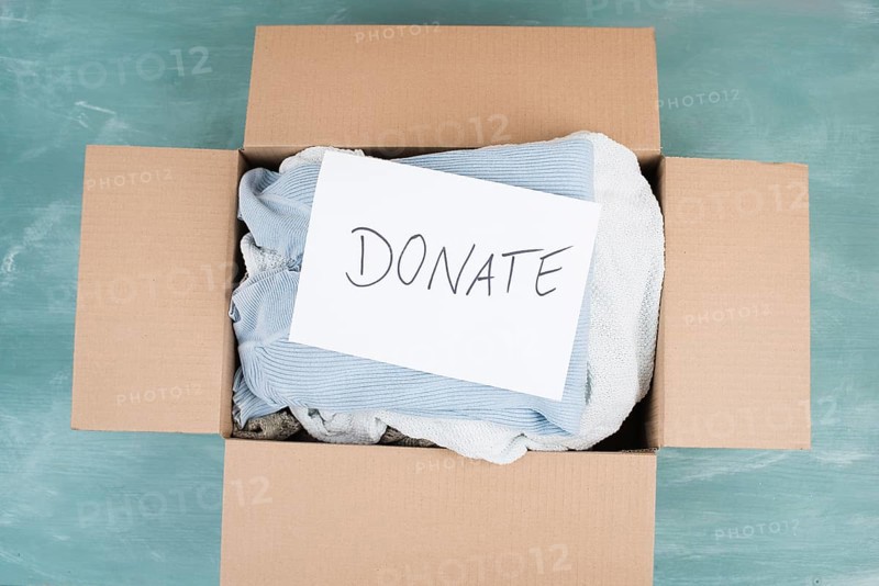 Package with used clothes for donation, second hand use for poor people, welfare and support concept, humanitarian act