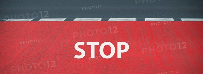 Stop is standing on the road, warning sign, take caution, finish line for a runner on the asphalt, sport concept