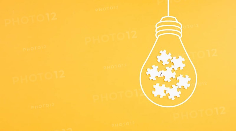 Light bulb with jigsaw or puzzle pieces, brainstorming for ideas, finding solution, solving a problem