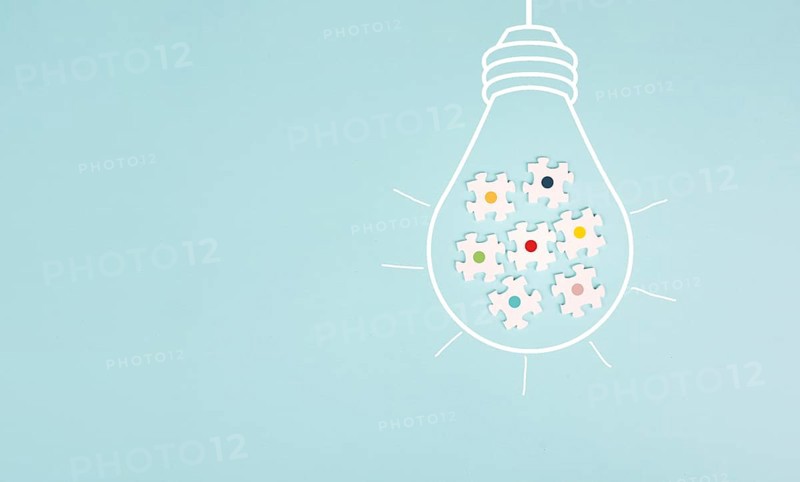 Light bulb with jigsaw or puzzle pieces, brainstorming for ideas, finding solution, solving a problem