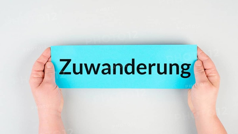 Immigration is standing in german language on the paper, new naturalization reform for immigrants and asylum seekers